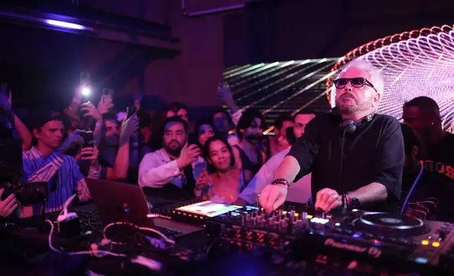 French musician Marc Cerrone performs during the DiscOlympics at Wanderlust night club at the 2024 Summer Olympics, Sunday, July 28, 2024, in Paris, France. (AP Photo/Natacha Pisarenko)