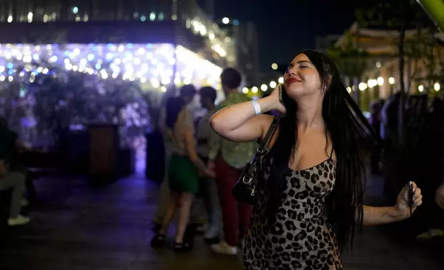 Apolline Wolak dances during the DiscOlympics at Wanderlust night club during the 2024 Summer Olympics, Sunday, July 28, 2024, in Paris, France. Cerrone, the legendary French disco artist, played at the DiscOlympics which paid homage to the root of dance music. (AP Photo/Natacha Pisarenko)