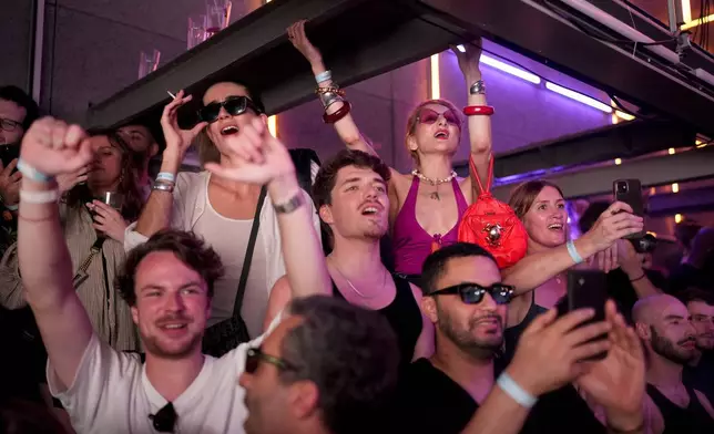 People dance as French musician Marc Cerrone performs during the DiscOlympics at Wanderlust night club at the 2024 Summer Olympics, Monday, July 29, 2024, in Paris, France. (AP Photo/Natacha Pisarenko)