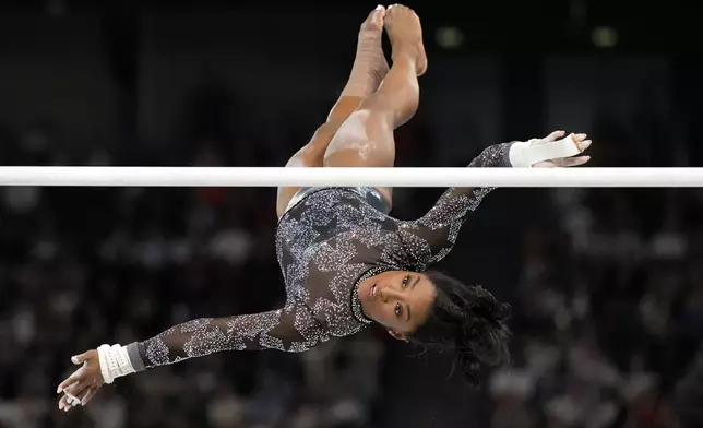 Simone Biles, of United States, competes on the uneven bars during a women's artistic gymnastics qualification round at Bercy Arena at the 2024 Summer Olympics, Sunday, July 28, 2024, in Paris, France. (AP Photo/Abbie Parr)