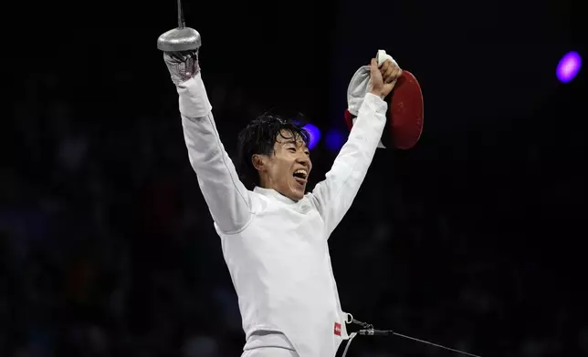 Japan's Koki Kano celebrates after winning the men's individual Epee final match against France's Yannik Borel during the 2024 Summer Olympics at the Grand Palais, Sunday, July 28, 2024, in Paris, France. (AP Photo/Andrew Medichini)