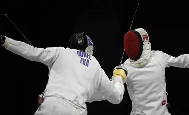 Japan's Koki Kano, right, competes with France's Yannik Borel in the men's individual Epee final match during the 2024 Summer Olympics at the Grand Palais, Sunday, July 28, 2024, in Paris, France. (AP Photo/Andrew Medichini)