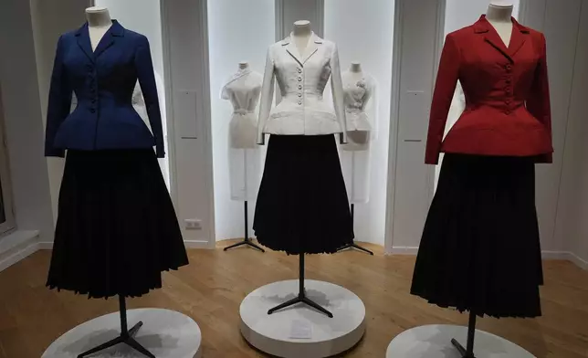 Dior Bar suits in the colors of the French flag are displayed inside the LVMH Pavilion, showcasing creations of the luxury brand related to the Paris 2024 Summer Olympics, Monday, July 22, 2024, in Paris. (AP Photo/Rebecca Blackwell)