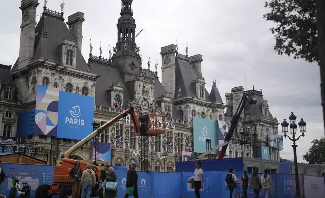 Construction barriers surround Hotel de Ville square, Wednesday, July 3, 2024 in Paris. Just three weeks before the Olympics, the excitement that was building up in the host city has mingled with anxiety about France’s political future. (AP Photo/Thibault Camus)