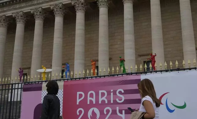 Copies of one of the most famous Greek statues, the Venus of Milo, are installed on the steps of the French National Assembly Wednesday, July 3, 2024 in Paris. Just three weeks before the Olympics, the excitement that was building up in the host city has mingled with anxiety about France’s political future. (AP Photo/Thibault Camus)