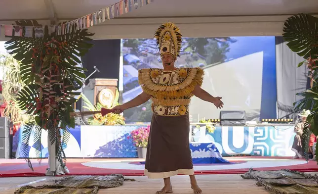 Locals perform during an opening ceremony for the 2024 Summer Olympics surfing competition, Friday, July 26, 2024, in Papara, Tahiti. (Ed Sloane/Pool Photo via AP)