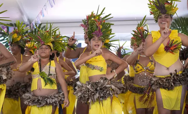 Dancers perform during an opening ceremony for the 2024 Summer Olympics surfing competition Friday, July 26, 2024, in Papara, Tahiti. (AP Photo/Gregory Bull)