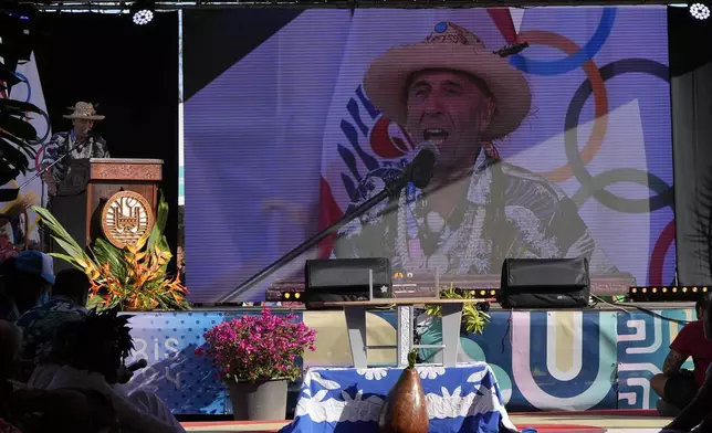 Fernando Aguerre, President of the International Surfing Association, speaks during an opening ceremony for the 2024 Summer Olympics surfing competition Friday, July 26, 2024, in Papara, Tahiti. (AP Photo/Gregory Bull)