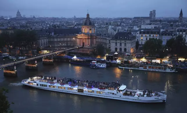 Team France cruise on the Seine River during the opening ceremony of the 2024 Summer Olympics, Friday, July 26, 2024 in Paris, France. (Richard Heathcote/Pool Photo via AP)