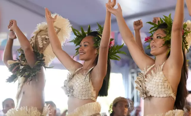 Dancers perform during an opening ceremony for the 2024 Summer Olympics surfing competition Friday, July 26, 2024, in Papara, Tahiti. (AP Photo/Gregory Bull)