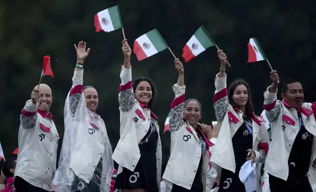 Team Mexico attends the opening ceremony for the 2024 Summer Olympics in Paris, France, Friday, July 26, 2024. (Steph Chambers/Pool Photo via AP)