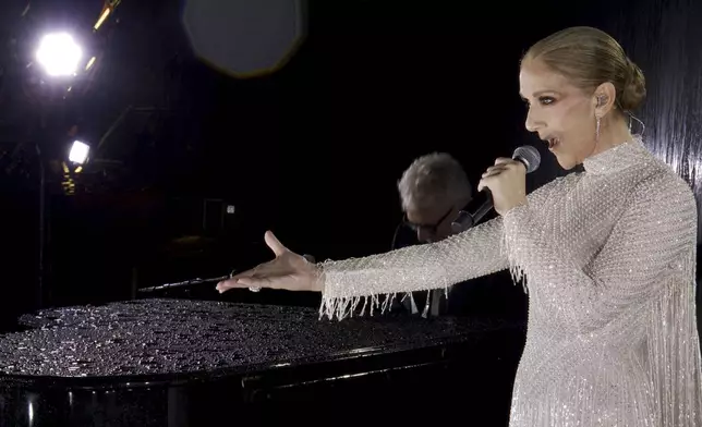 This photo released by the Olympic Broadcasting Services shows Canadian Singer Celine Dion performing at the Eiffel Tower during the opening ceremony for the 2024 Summer Olympics in Paris, France, Friday, July 26, 2024. (Olympic Broadcasting Services via AP)