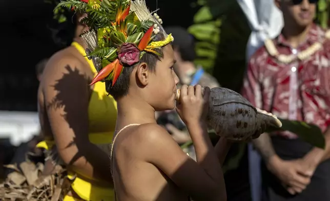 Locals perform during an opening ceremony for the 2024 Summer Olympics surfing competition, Friday, July 26, 2024, in Papara, Tahiti. (Ed Sloane/Pool Photo via AP)