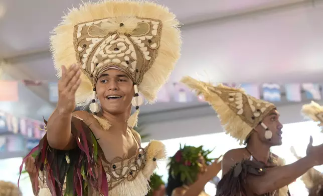 Dancers perform during an opening ceremony for the 2024 Summer Olympics surfing competition Friday, July 26, 2024, in Papara, Tahiti. (AP Photo/Gregory Bull)