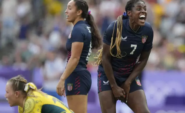 United States' Naya Tapper, right reacts after United States' Alex Sedrick, centre, scored the winning try during the women's bronze medal Rugby Sevens match between the United States and Australia at the 2024 Summer Olympics, in the Stade de France, in Saint-Denis, France, Tuesday, July 30, 2024. The US won the match 14-12. (AP Photo/Vadim Ghirda)