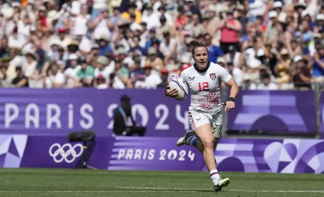 United States' Kristi Kirshe runs on to score a try during the women's semifinal Rugby Sevens match between New Zealand and the United States at the 2024 Summer Olympics, in the Stade de France, in Saint-Denis, France, Tuesday, July 30, 2024. (AP Photo/Tsvangirayi Mukwazhi)