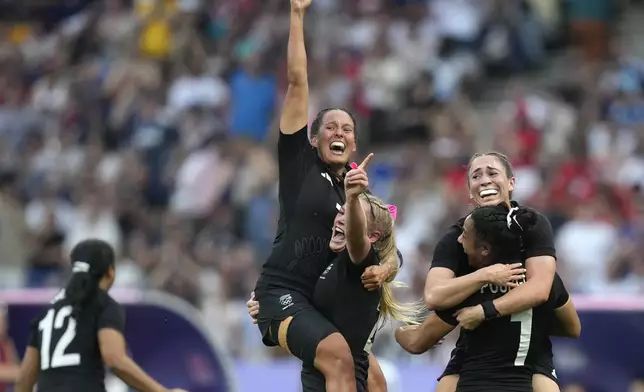 New Zealand team member celebrate after winning the women's gold medal Rugby Sevens match between New Zealand and Canada at the 2024 Summer Olympics, in the Stade de France, in Saint-Denis, France, Tuesday, July 30, 2024. New Zealand won the match 19-12. (AP Photo/Vadim Ghirda)