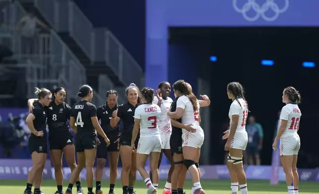 New Zealand, left and United States teams shake hands after the end of the women's semifinal Rugby Sevens match between New Zealand and the United States at the 2024 Summer Olympics, in the Stade de France, in Saint-Denis, France, Tuesday, July 30, 2024. New Zealand won the match and advance to the final 24-12. (AP Photo/Vadim Ghirda)