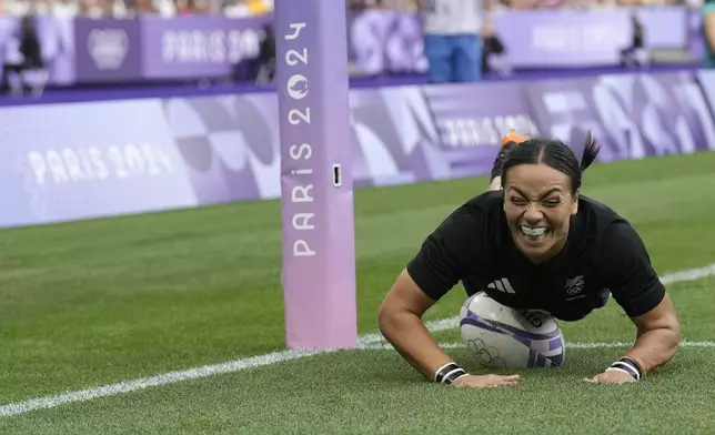 New Zealand's Stacey Waaka dives over the line to score a try during the women's gold medal Rugby Sevens match between New Zealand and Canada at the 2024 Summer Olympics, in the Stade de France, in Saint-Denis, France, Tuesday, July 30, 2024. (AP Photo/Vadim Ghirda)