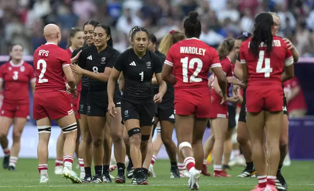 New Zealand team members shake hands with members of the Canadian team after winning the women's gold medal Rugby Sevens match between New Zealand and Canada at the 2024 Summer Olympics, in the Stade de France, in Saint-Denis, France, Tuesday, July 30, 2024. New Zealand won the match 19-12. (AP Photo/Vadim Ghirda)