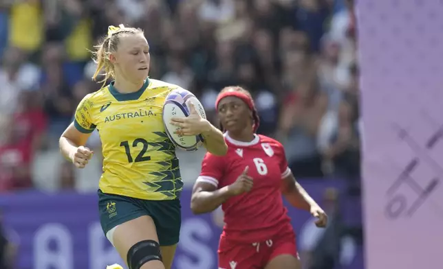 Australia's Maddison Levi runs over the line and scores a try during the women's semifinal Rugby Sevens match between Canada and Australia at the 2024 Summer Olympics, in the Stade de France, in Saint-Denis, France, Tuesday, July 30, 2024. (AP Photo/Vadim Ghirda)