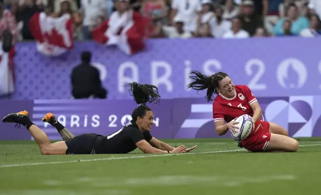 Canada's Alysha Corrigan score a try during the women's gold medal Rugby Sevens match between New Zealand and Canada at the 2024 Summer Olympics, in the Stade de France, in Saint-Denis, France, Tuesday, July 30, 2024. (AP Photo/Vadim Ghirda)