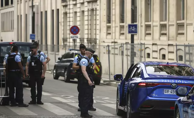 Police officers check an accredited vehicle for Paris olympics at the 2024 Summer Olympics, Saturday, July 20, 2024, in Paris, France. (AP Photo/Thomas Padilla)