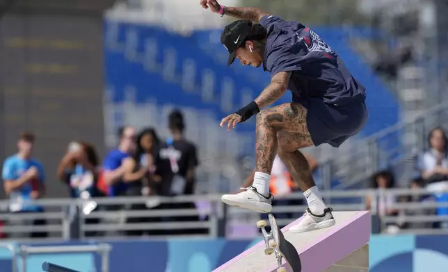 Nyjah Huston, of the United States, competes in the men's skateboard street preliminaries at the 2024 Summer Olympics, Monday, July 29, 2024, in Paris, France. (AP Photo/Frank Franklin II)