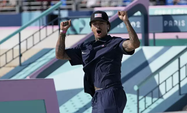 Nyjah Huston, of the United States, celebrates after his second run during the men's skateboard street final at the 2024 Summer Olympics, Monday, July 29, 2024, in Paris, France. (AP Photo/Frank Franklin II)