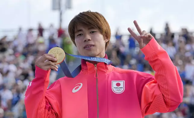 Yuto Horigome, of Japan, poses after winning the gold medal in the men's skateboard street final at the 2024 Summer Olympics, Monday, July 29, 2024, in Paris, France. (AP Photo/Frank Franklin II)