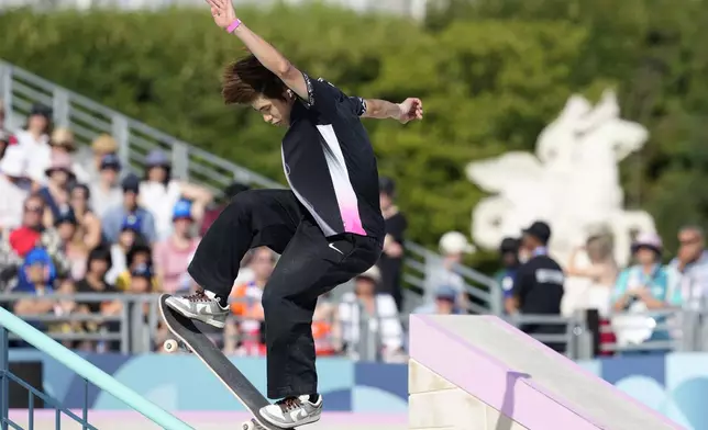 Yuto Horigome, of Japan, executes a trick during the men's skateboard street final at the 2024 Summer Olympics, Monday, July 29, 2024, in Paris, France. (AP Photo/Dar Yasin)