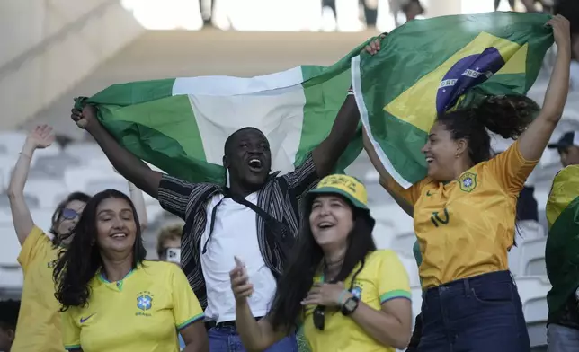 Fans of Brazil and Nigeria cheer during the women's Group C soccer match between Nigeria and Brazil at the Bordeaux stadium during the 2024 Summer Olympics, Thursday, July 25, 2024, in Bordeaux, France. (AP Photo/Moises Castillo)