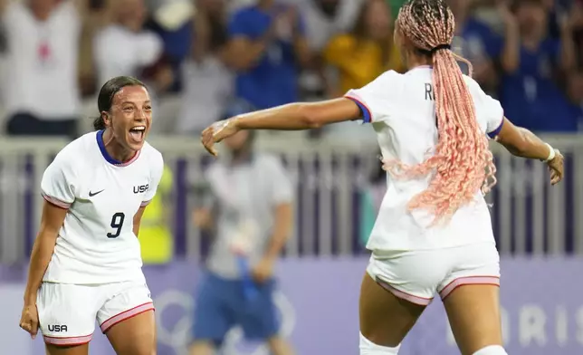 United States' Mallory Swanson, left, reacts after teammate Trinity Rodman, right, scored a goal during a women's group B match between the United States and Zambia at Nice Stadium at the 2024 Summer Olympics, Thursday, July 25, 2024, in Nice, France. (AP Photo/Julio Cortez)