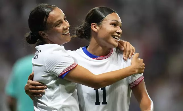 United States' Mallory Swanson, left, reacts with teammate Sophia Smith after scoring her side's third goal during a women's group B match between the United States and Zambia at Nice Stadium at the 2024 Summer Olympics, Thursday, July 25, 2024, in Nice, France. (AP Photo/Julio Cortez)