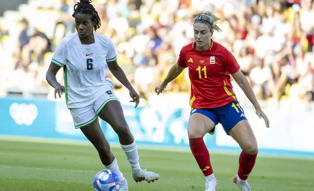 Nigeria's Esther Okoronkwo, left, vies for the ball with Spain's Alexia Putellas during the women's Group C match between, Spain and Nigeria, at La Beaujoire Stadium, during the 2024 Summer Olympics Sunday, July 28, 2024, in Nantes, France. (AP Photo/Jeremias Gonzalez)