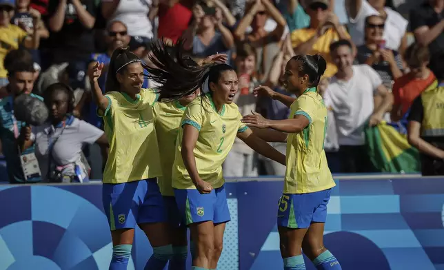 Brazil's Jheniffer celebrates scoring her team's first goal with teammates, during the women's group C match between Brazil and Japan at the Parc des Princes during the 2024 Summer Olympics, Sunday, July 28, 2024, in Paris, France. (AP Photo/Aurelien Morissard)