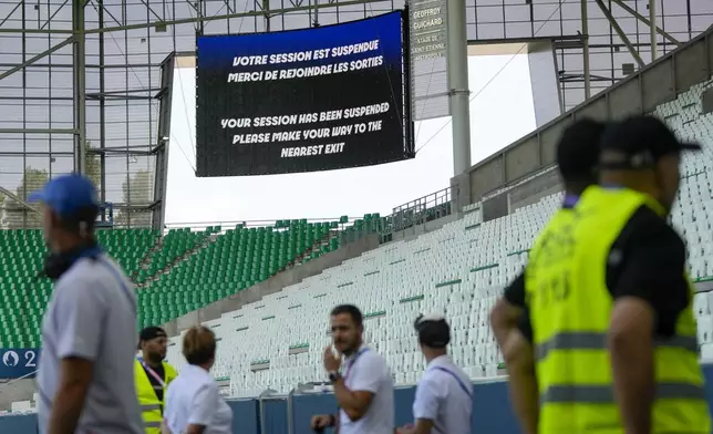 The video screen announces that the match has been suspended during the men's Group B soccer match between Argentina and Morocco at Geoffroy-Guichard Stadium at the 2024 Summer Olympics, Wednesday, July 24, 2024, in Saint-Etienne, France. (AP Photo/Silvia Izquierdo)