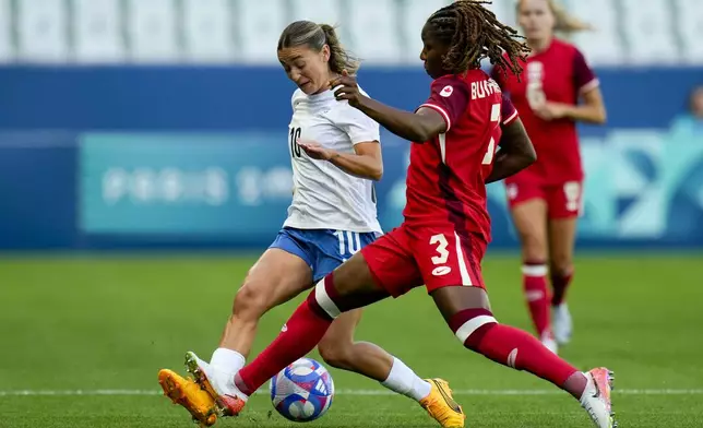 New Zealand's Indiah-Paige Riley, left, and Canada's Kadeisha Buchanan compete for the ball during the women's Group A soccer match between Canada and New Zealand at Geoffroy-Guichard stadium during the 2024 Summer Olympics, Thursday, July 25, 2024, in Saint-Etienne, France. (AP Photo/Silvia Izquierdo)