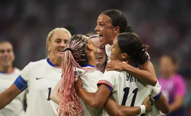 Players from the United States celebrate after Sophia Smith scored their side's first goal, during the women's Group B soccer match between the United States and Germany at the Velodrome stadium, during the 2024 Summer Olympics, Sunday, July 28, 2024, in Marseille, France. (AP Photo/Daniel Cole)