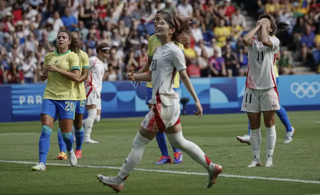 Japan's Tanaka Mina, center, reacts during the women's group C match between Brazil and Japan at the Parc des Princes, during the 2024 Summer Olympics, Sunday, July 28, 2024, in Paris, France. (AP Photo/Aurelien Morissard)