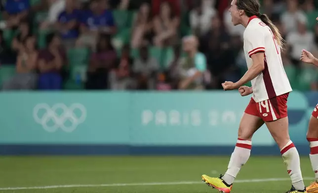 Canada's Vanessa Gille celebrates scoring her side's second goal during the women's Group A soccer match between Canada and France at Geoffroy-Guichard stadium during the 2024 Summer Olympics, Sunday, July 28, 2024, in Saint-Etienne, France. (AP Photo/Silvia Izquierdo)