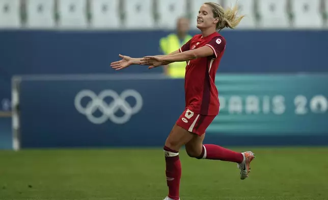 Canada's Cloe Lacasse celebrates scoring her side's first goal during the women's Group A soccer match between Canada and New Zealand at Geoffroy-Guichard stadium during the 2024 Summer Olympics, Thursday, July 25, 2024, in Saint-Etienne, France. (AP Photo/Silvia Izquierdo)