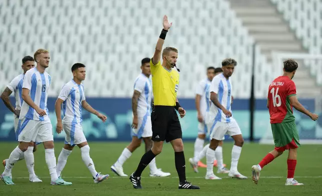 Referee Glenn Nyberg disallows a goal scored by Argentina's Cristian Medina during the Men's Group B soccer match between Argentina and Morocco at Geoffroy-Guichard stadium during the 2024 Summer Olympics, Wednesday, July 24, 2024, in Saint-Etienne, France. (AP Photo/Silvia Izquierdo)