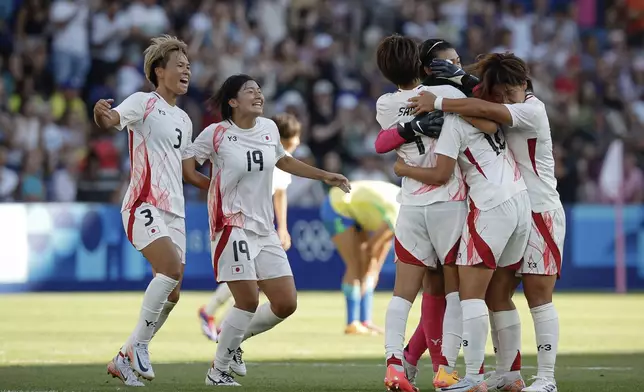 Japan's players celebrate after winning against Brazil, during the women's group C match between Brazil and Japan at the Parc des Princes, during the 2024 Summer Olympics, Sunday, July 28, 2024, in Paris, France. (AP Photo/Aurelien Morissard)