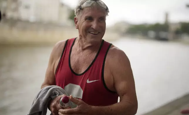 Joel Stratte-McClure, 75, of the US, smiles after a short swim in the Seine river, Thursday, July 4, 2024 in Paris. The Seine River has been found unsafe according to test results published last Friday, less than a month before the Paris Olympics. (AP Photo/Thibault Camus)