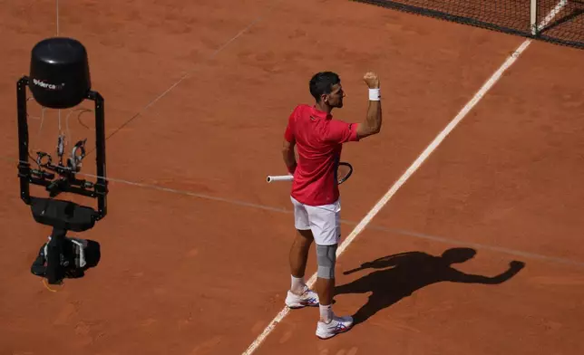 Serbia's Novak Djokovic celebrates after defeating Spain's Rafael Nadal in their men's singles second round match at the Roland Garros stadium at the 2024 Summer Olympics, Monday, July 29, 2024, in Paris, France. Novak Djokovic dominated rival Rafael Nadal to win 6-1, 6-4 at the Paris Olympics in the second round. (AP Photo/Manu Fernandez)