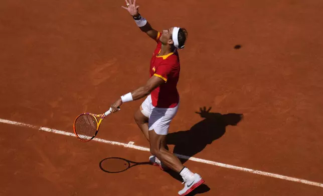 Spain's Rafael Nadal serves the ball to Serbia's Novak Djokovic during their men's singles second round match at the 2024 Summer Olympics, Monday, July 29, 2024, at the Roland Garros stadium in Paris, France. (AP Photo/Manu Fernandez)