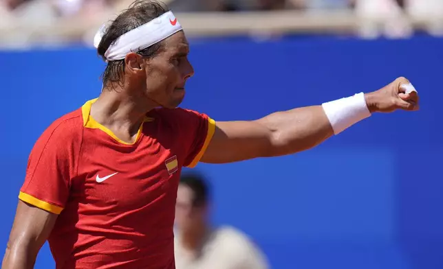 Spain's Rafael Nadal celebrates winning a point as he plays Serbia's Novak Djokovic during their men's singles second round match at the 2024 Summer Olympics, Monday, July 29, 2024, at the Roland Garros stadium in Paris, France. (AP Photo/Andy Wong)