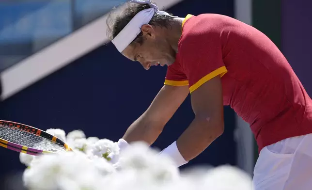 Spain's Rafael Nadal reacts as he plays Serbia's Novak Djokovic during their men's singles second round match at the 2024 Summer Olympics, Monday, July 29, 2024, at the Roland Garros stadium in Paris, France. (AP Photo/Andy Wong)