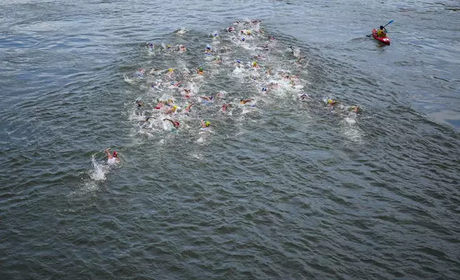 Athletes compete during the swim leg of the women's individual triathlon competition at the 2024 Summer Olympics, Wednesday, July 31, 2024, in Paris, France. (AP Photo/David Goldman)